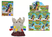 Kandy Toys Pop Up Dino Game toy with colorful dinosaur figures and game components on a flat surface.