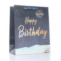 Large teal gift bag with "Happy Birthday" print, shown in a pack of six Tulip brand birthday gift bags.