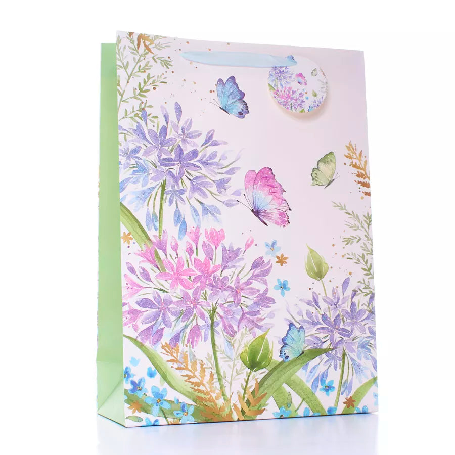 Large Tulip gift bag featuring colorful flowers and butterfly designs, perfect for special occasions, with a 6-pack of extra large bags.