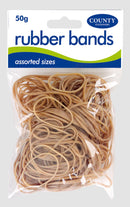 Natural white rubber bands in 50g pack by County Stationery, shown stretched around papers and office supplies.