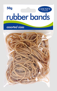 Natural white rubber bands in 50g pack by County Stationery, shown stretched around papers and office supplies.